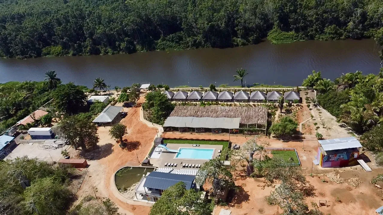 Aerial view of the resort's pool, playground and colourful staff buildings