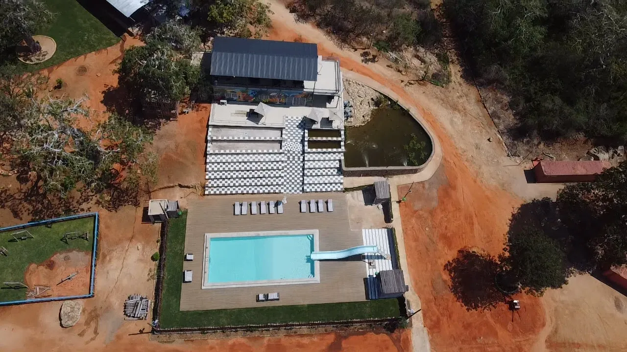 Aerial view of the resort's swimming pool, waterslide and fitness building